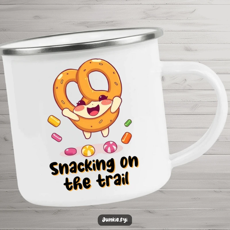Funny pretzel character catching candy pieces on a rugged camping mug, ready for outdoor fun and laughter.