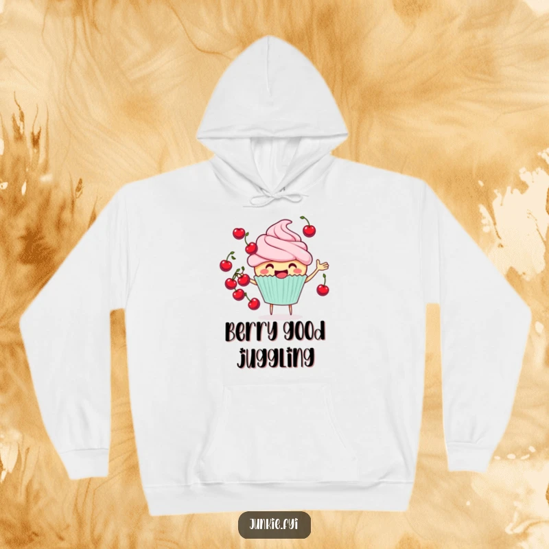 Funny cheerful cupcake hoodie juggling cherries, a cozy and humorous apparel item, perfect for gifting.